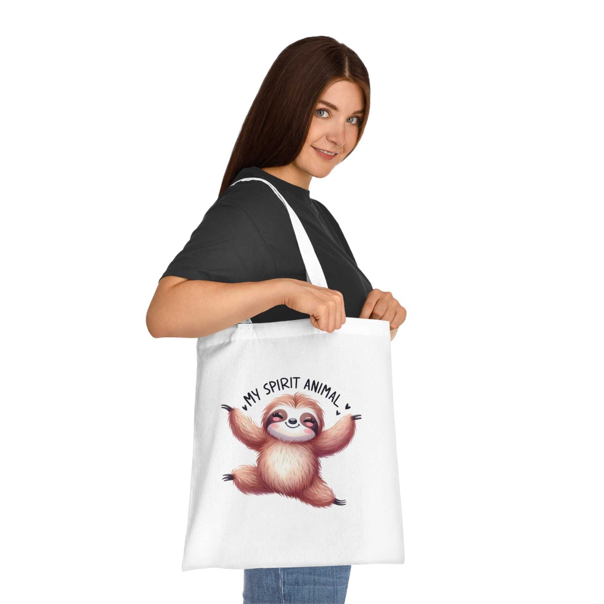 Cotton tote bag with cute sloth design, ideal for essentials and gifting, available in 6 colors.