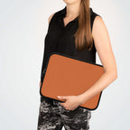 Bold orange neoprene laptop sleeve with soft foam lining and dual zipper, lightweight and waterproof design.