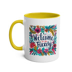 Cheeky "Welcome To The Fuckery" coffee mug with floral design, glossy finish, and yellow interior handle.