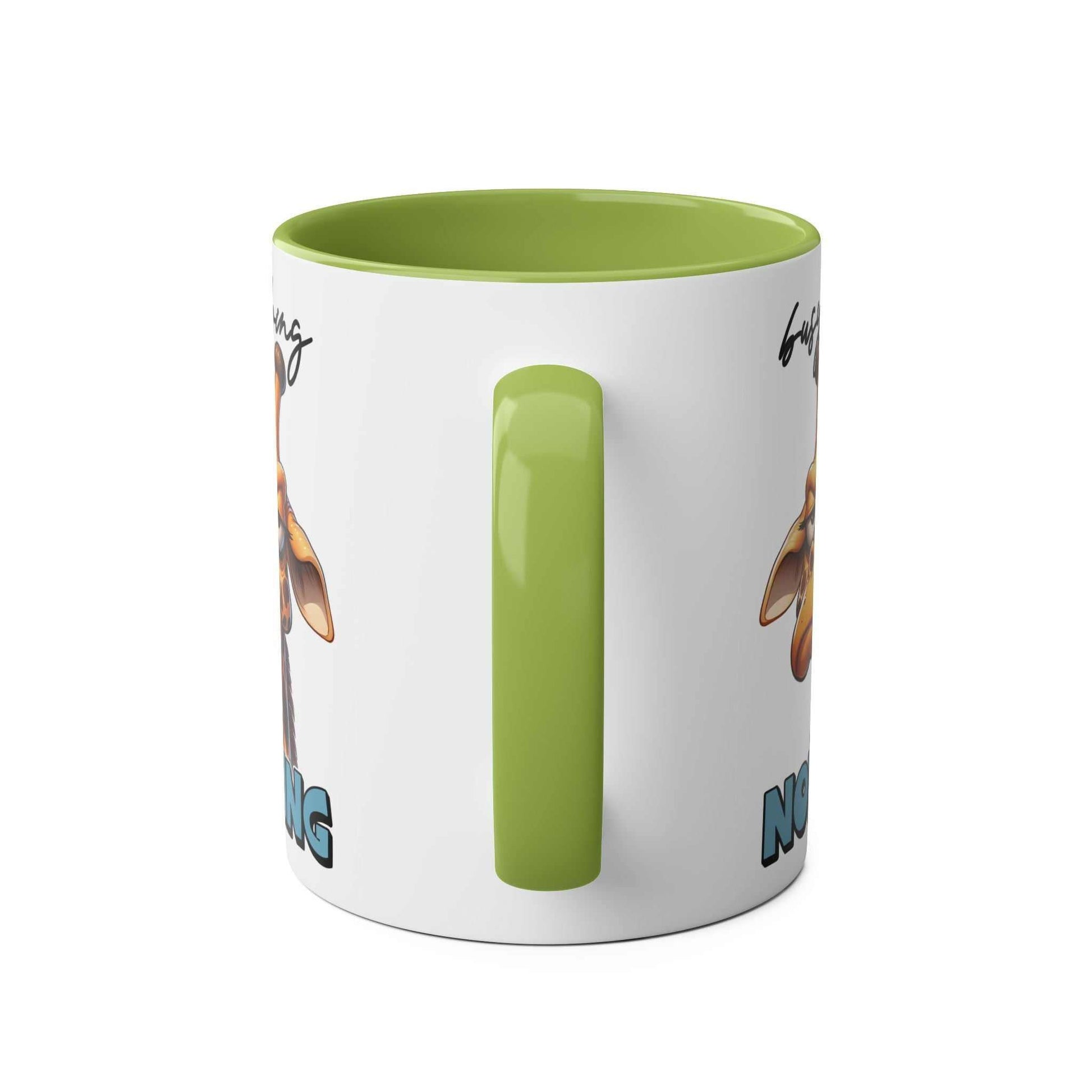 Giraffe-themed coffee mug with "Busy Doing Nothing" text, green handle, 11oz ceramic, dishwasher safe.