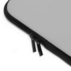 Close-up of silver neoprene laptop sleeve with black dual zipper and soft foam lining
