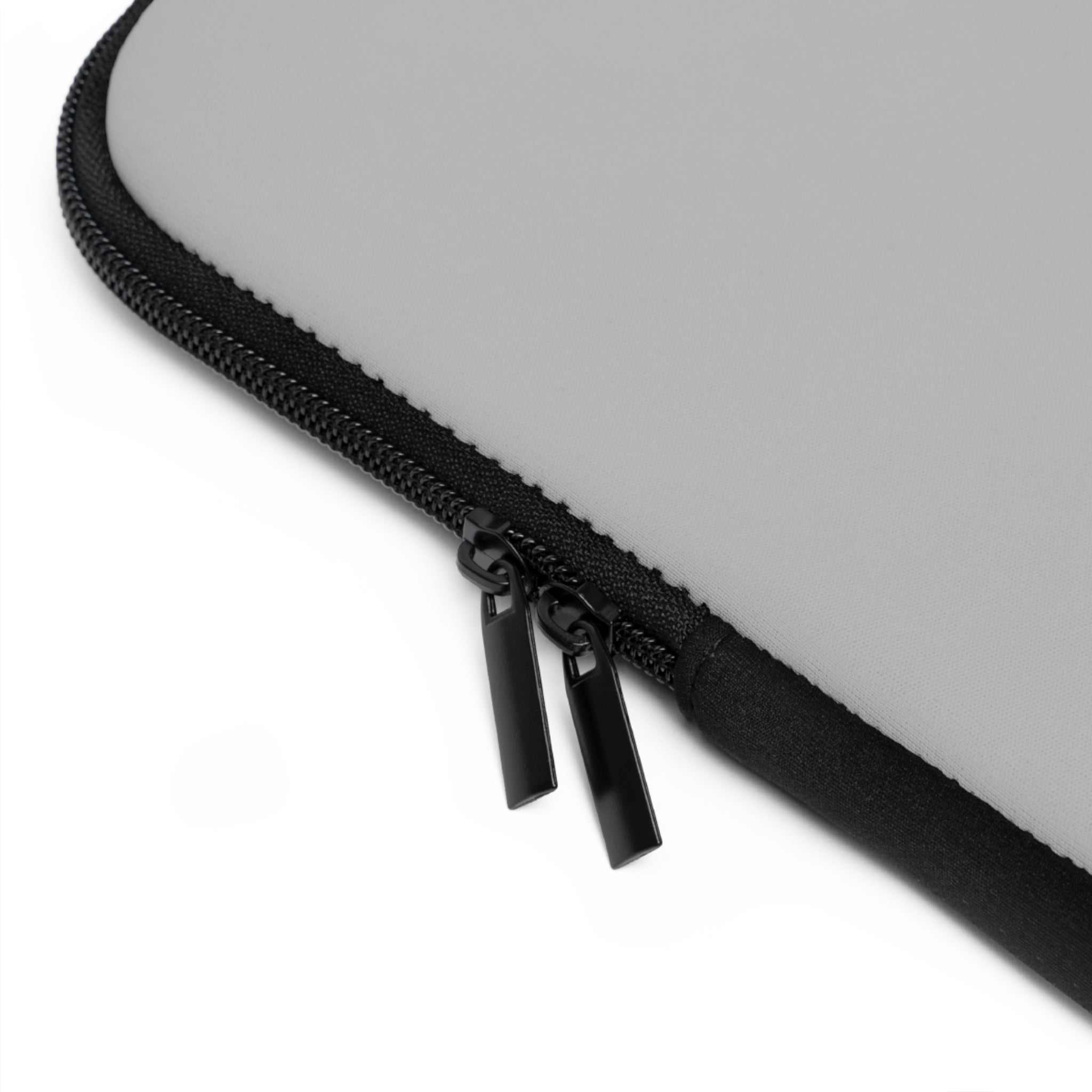 Close-up of silver neoprene laptop sleeve with black dual zipper and soft foam lining