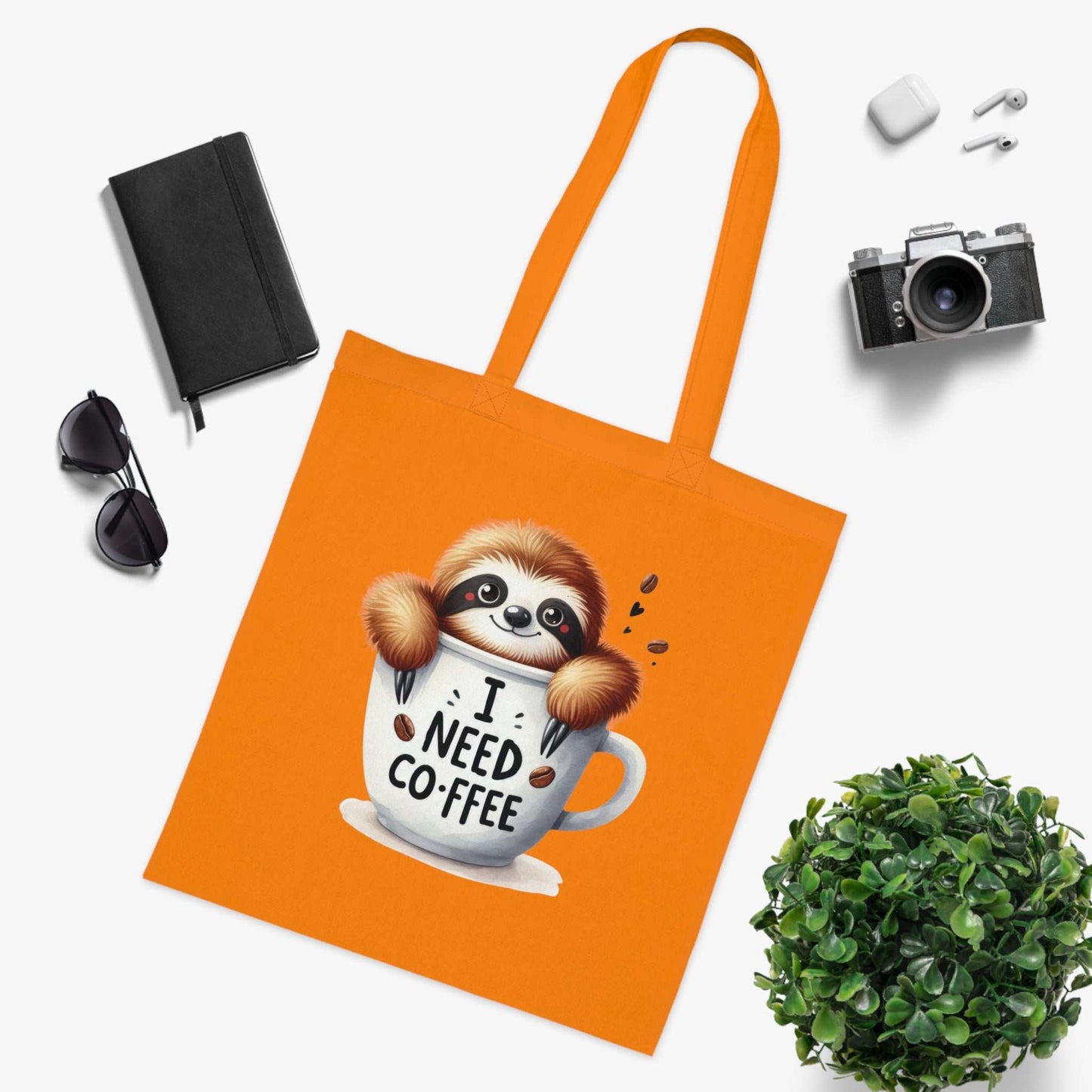 Orange cotton tote bag with a cute sloth design and coffee-themed print, ideal for sloth lovers.