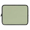 Sage green laptop sleeve made of durable neoprene with soft foam lining and dual zipper closure.