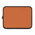 Bold orange laptop sleeve made of durable neoprene with soft foam lining and dual zipper closure.