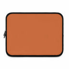 Bold orange neoprene laptop sleeve with black trim and dual zipper closure for protection and style
