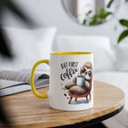 Cute sloth coffee mug with whimsical design and yellow handle on a wooden table.