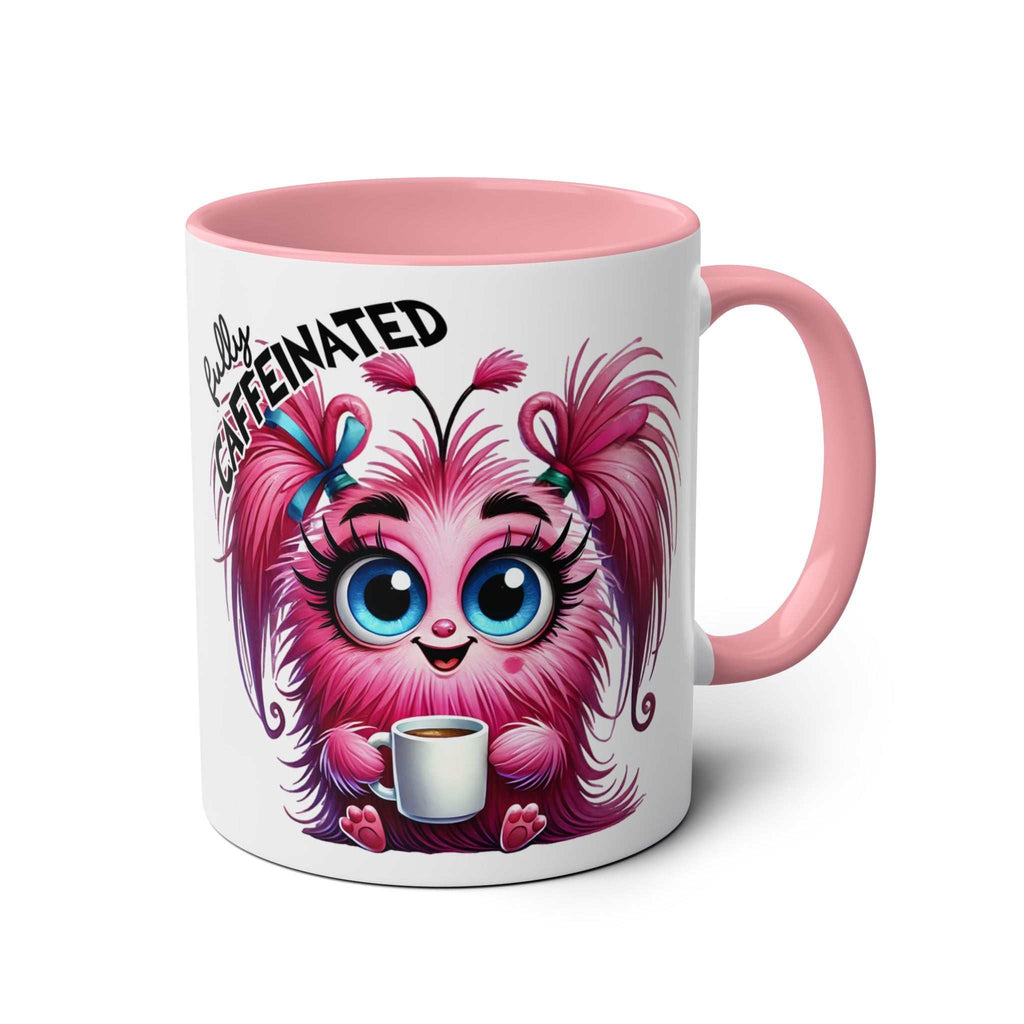 Fun sarcastic coffee mug with pink handle, featuring a cute, fuzzy creature holding a coffee cup and the text "Fully Caffeinated."