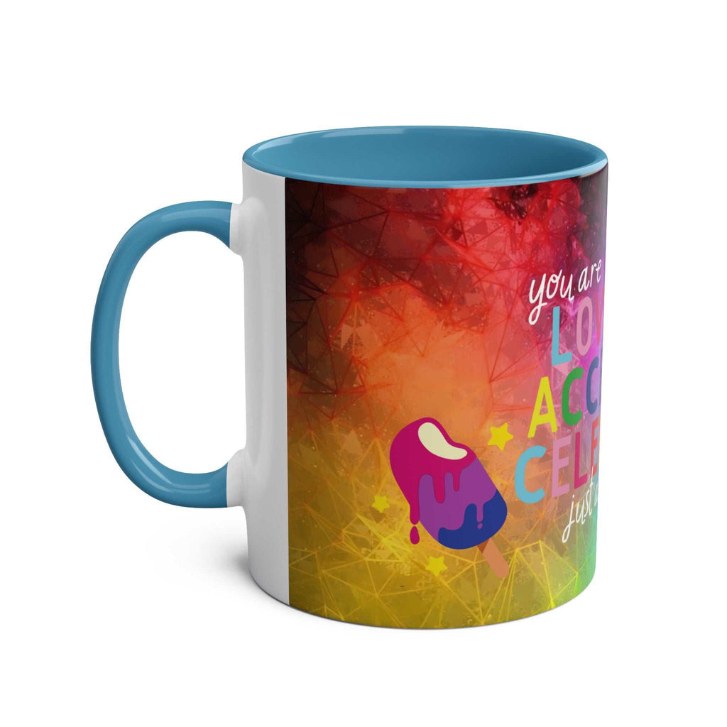 LGBTQ+ Pride mug with vibrant rainbow design and blue handle.