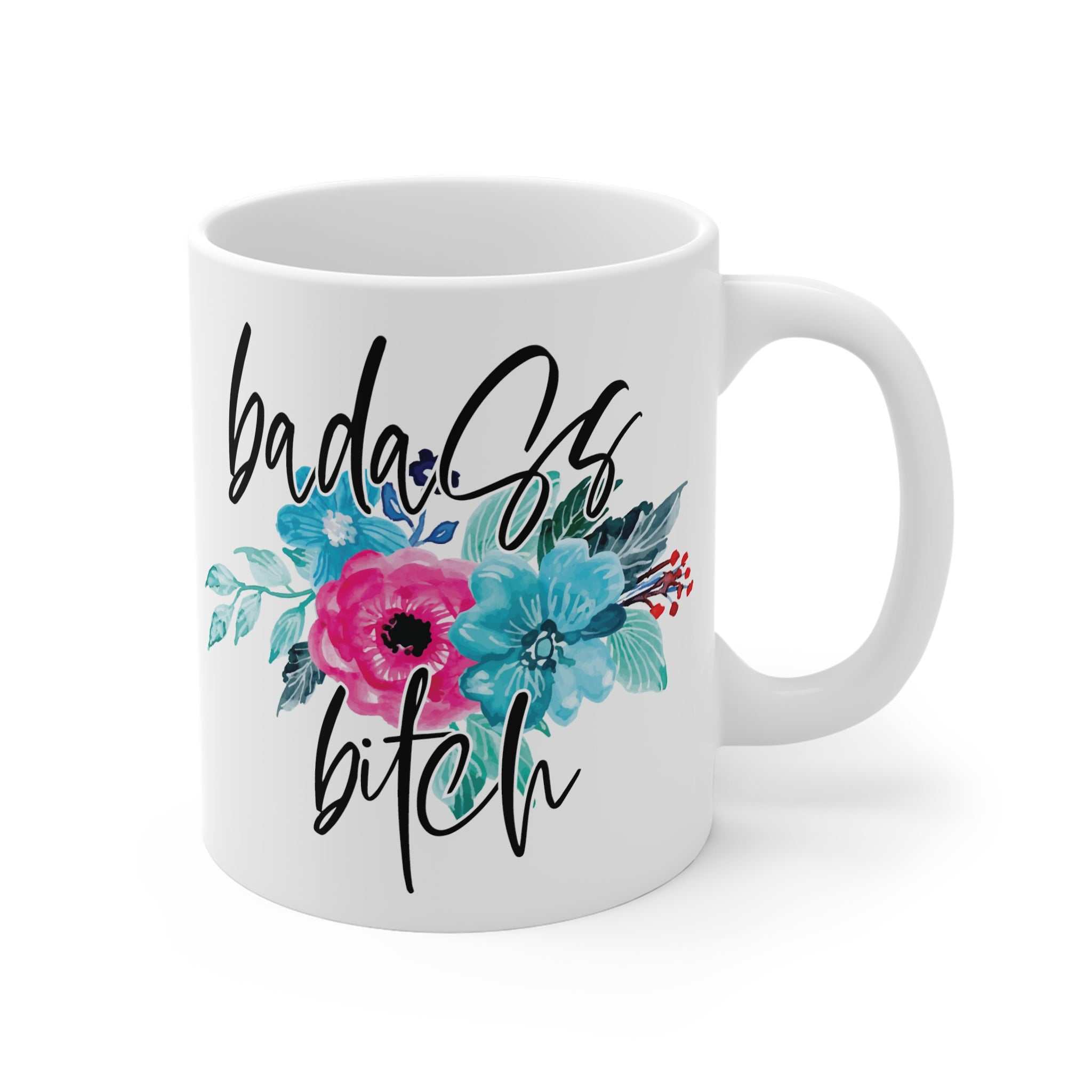 White ceramic mug with "badass bitch" text and colorful floral design, 11oz, glossy finish, microwave and dishwasher safe.