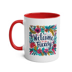 Welcome To The Fuckery coffee mug with floral design, red handle, and interior.