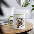 Cute sloth coffee mug with green interior and whimsical design on wooden table.