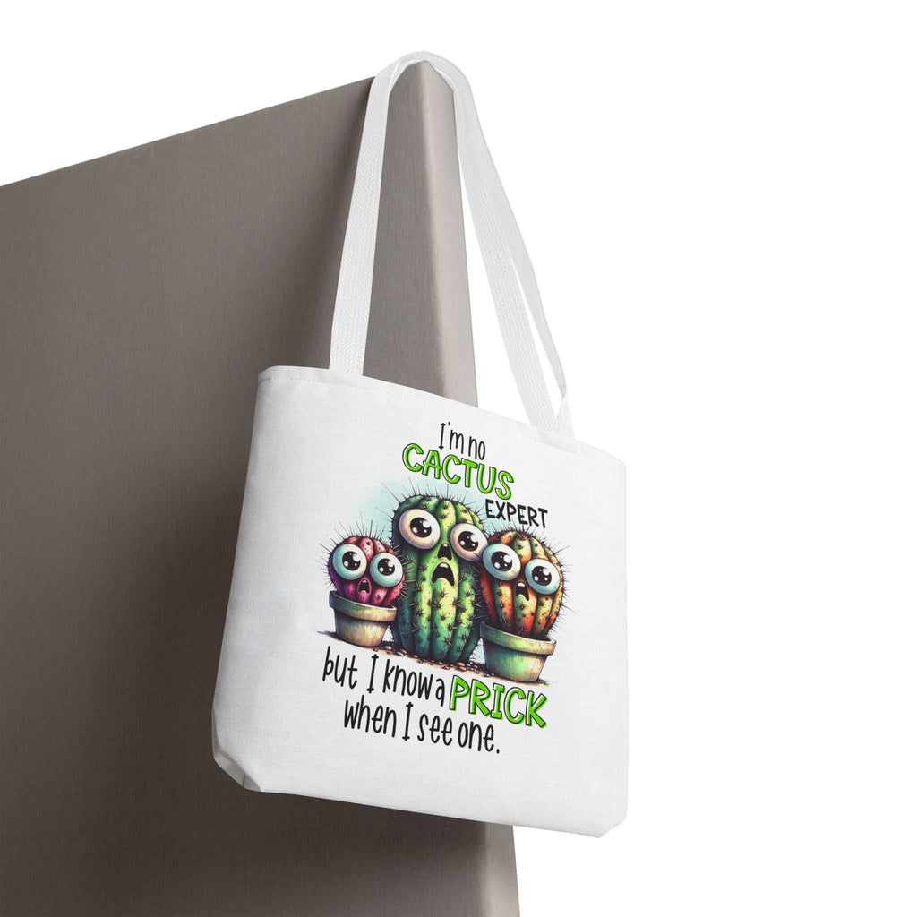 Fun cactus tote bag with cheeky design, multiple sizes, durable spun polyester, and colorful handles