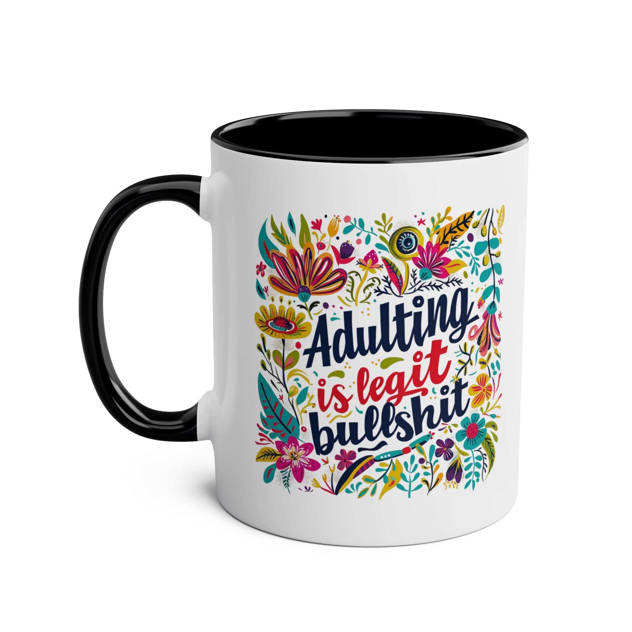 Black and white ceramic coffee mug with colorful floral design and text "Adulting Is Bullshit".