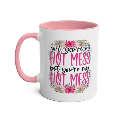 Hot Mess Coffee Mug with pink handle, colorful floral design, and playful slogan.