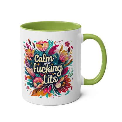Cheeky "Calm Your Tits" coffee mug with colorful floral design and green interior.