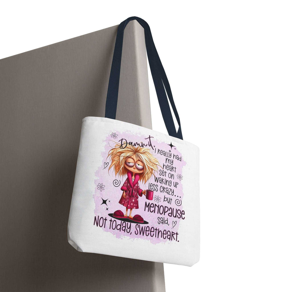 Cheeky menopause humour tote bag with durable spun polyester, available in three sizes and five handle colors.
