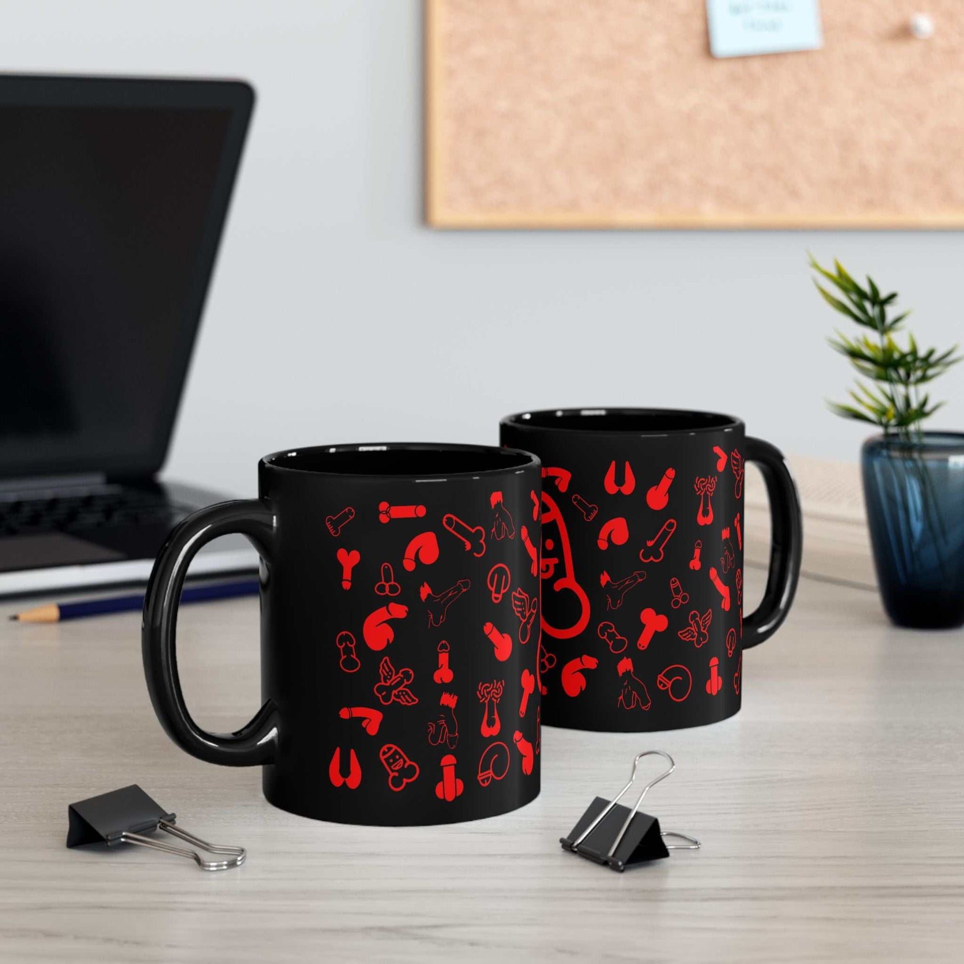 Black ceramic mug with red willie print, playful design, available in 11oz and 15oz sizes.