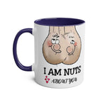 White ceramic 11oz "I Am Nuts About You" mug with purple handle and rim featuring cheeky nut cartoon design and playful text