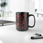 Black ceramic mug with playful red willies print, available in 11oz and 15oz sizes, on a desk.