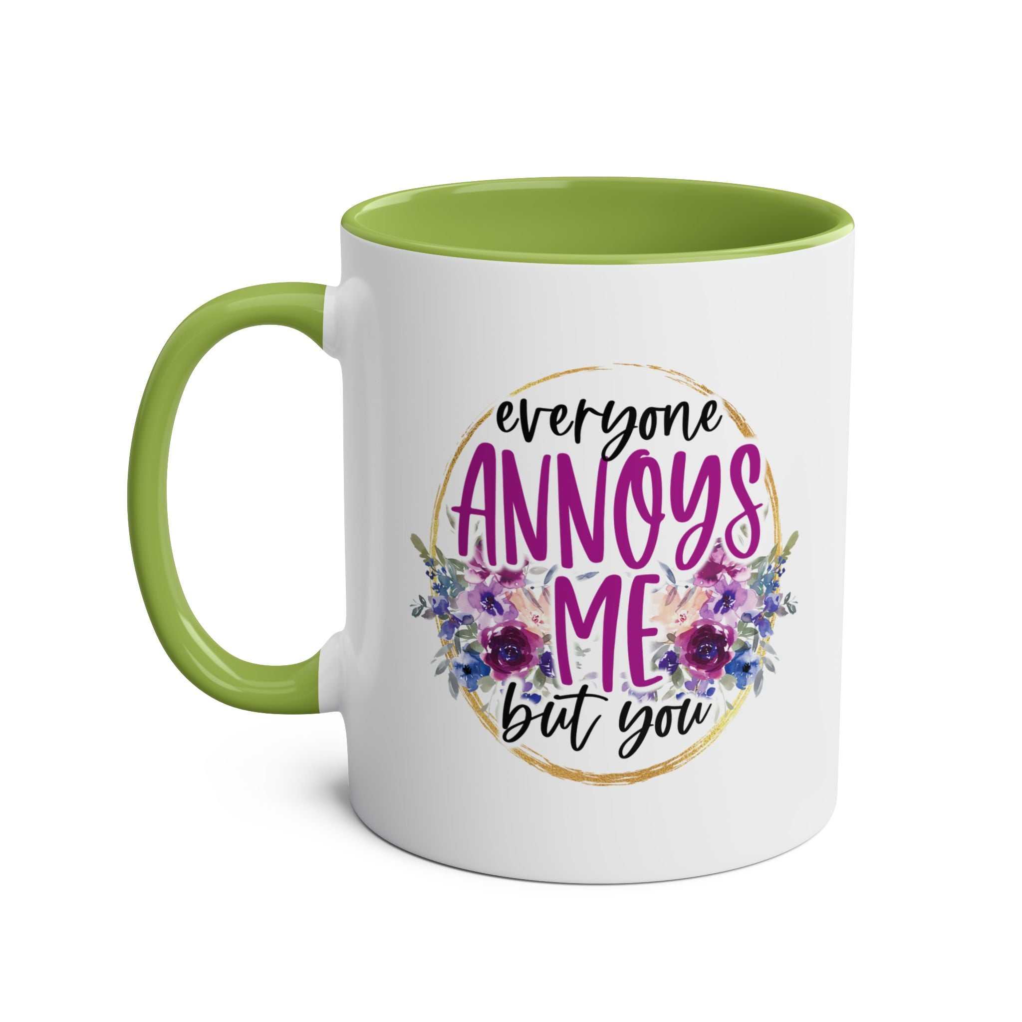 Everyone Annoys Me But You coffee mug with floral design and green handle.