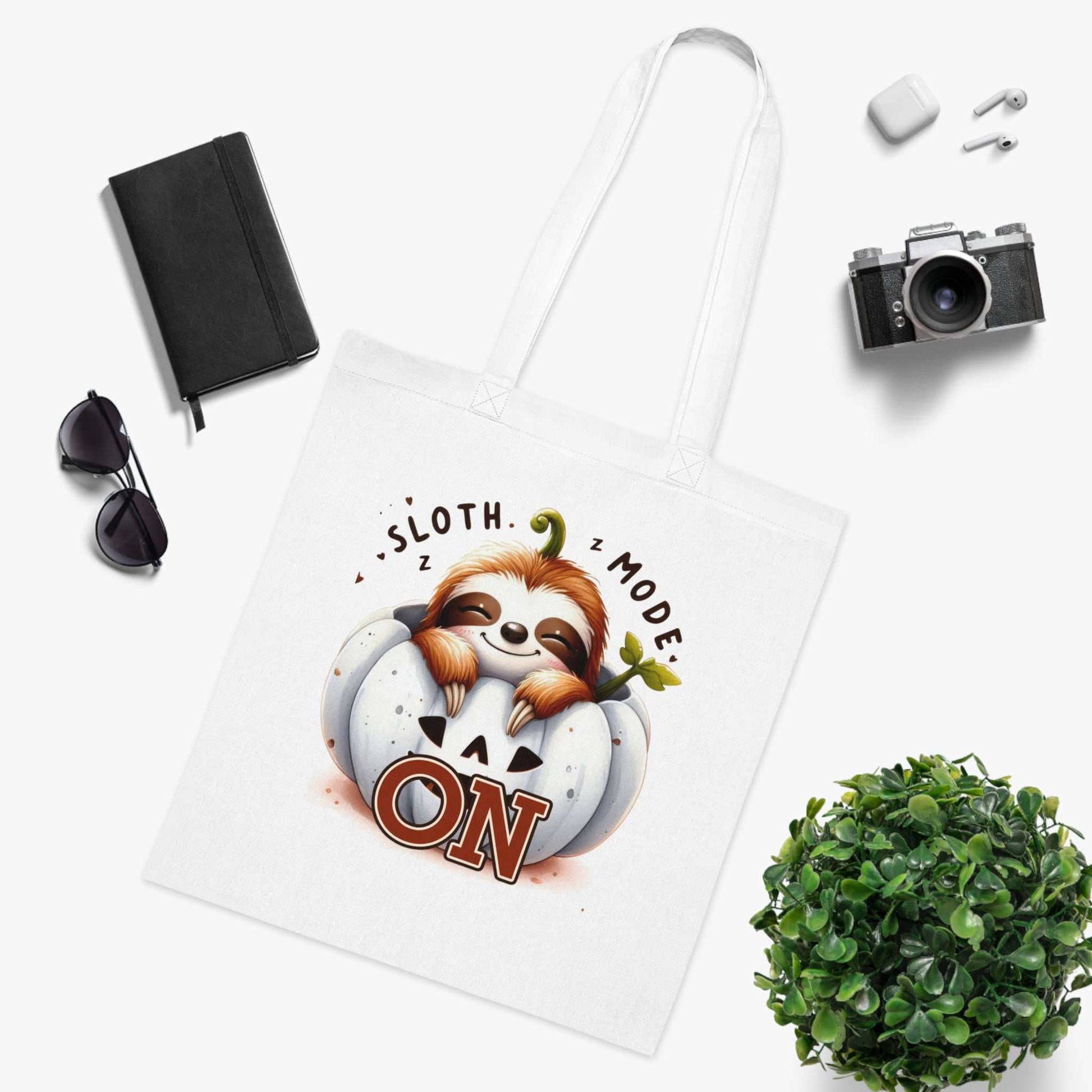 Cotton tote with cute sloth design, perfect for carrying essentials.