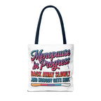 Menopause in Progress tote bag with cheeky design, durable spun polyester, multiple sizes and handle colors, perfect for errands and gifts