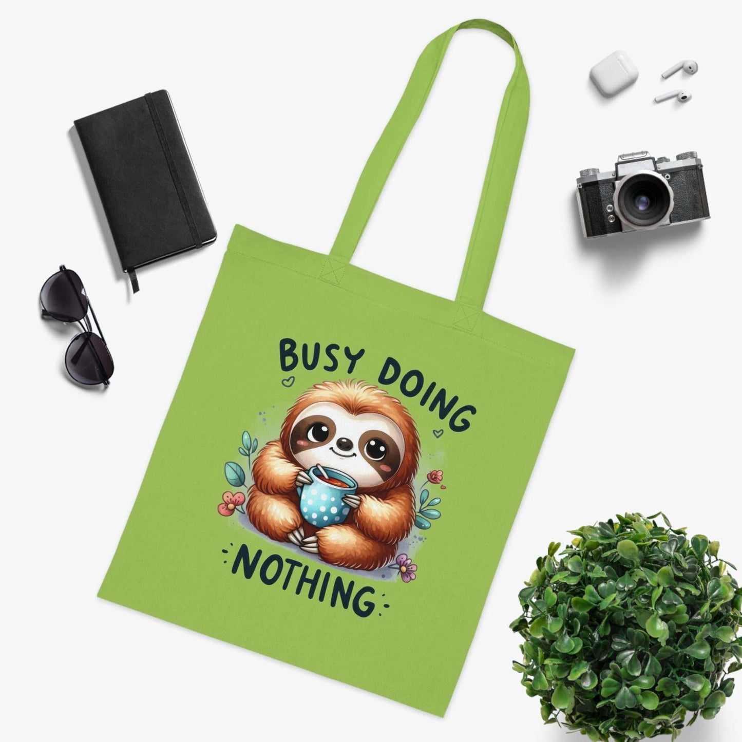 Cute sloth tote bag with vibrant design and colorful text, ideal for carrying essentials.