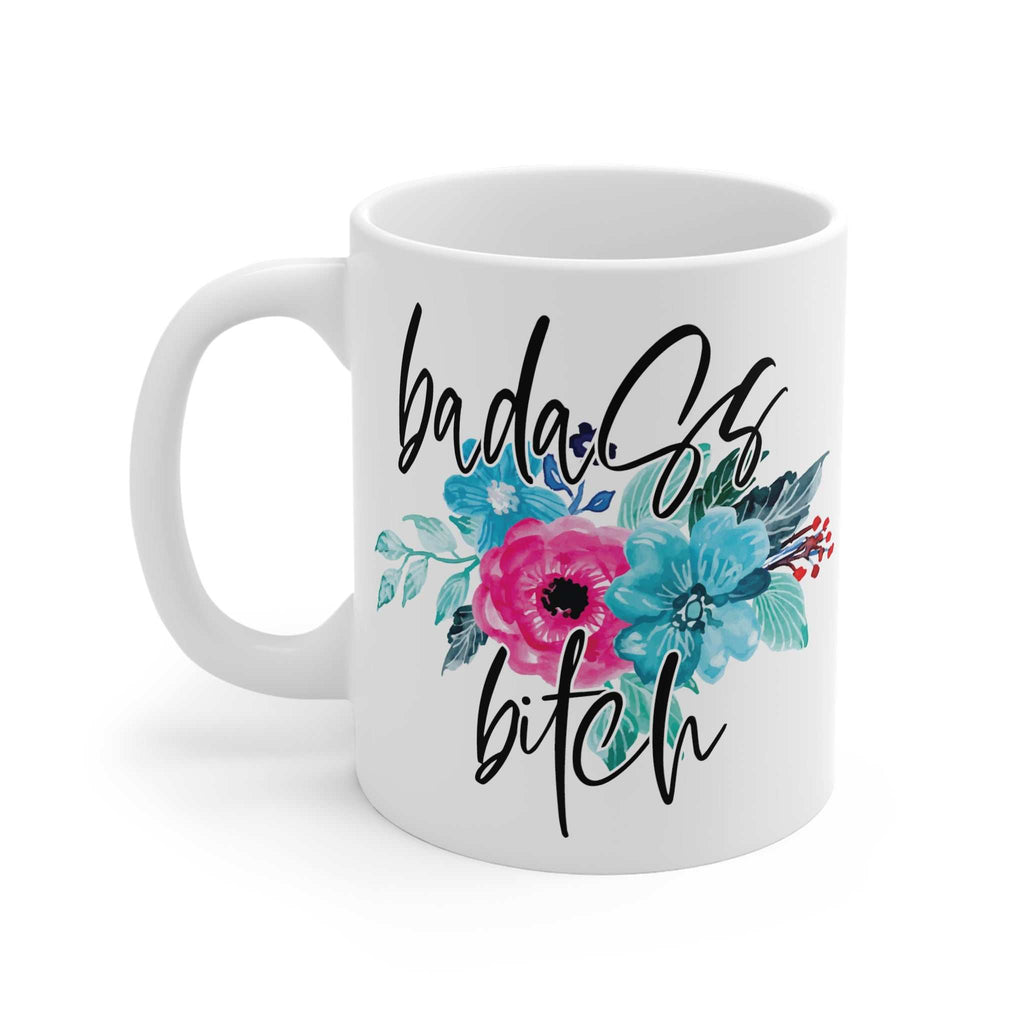White ceramic coffee mug with "badass bitch" text and colorful floral design, 11oz glossy finish, microwave and dishwasher safe