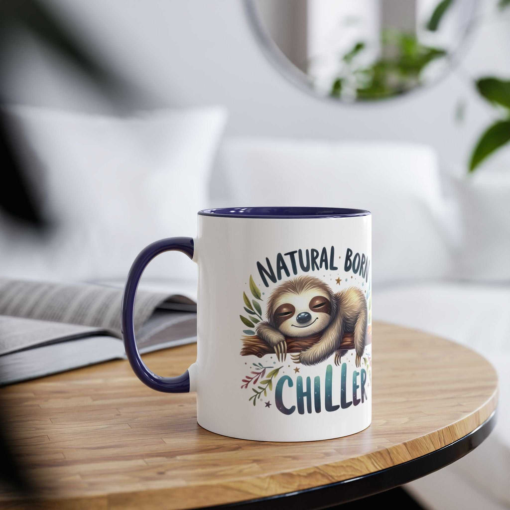 Cute sloth coffee mug with "Natural Born Chiller" design on wooden table.