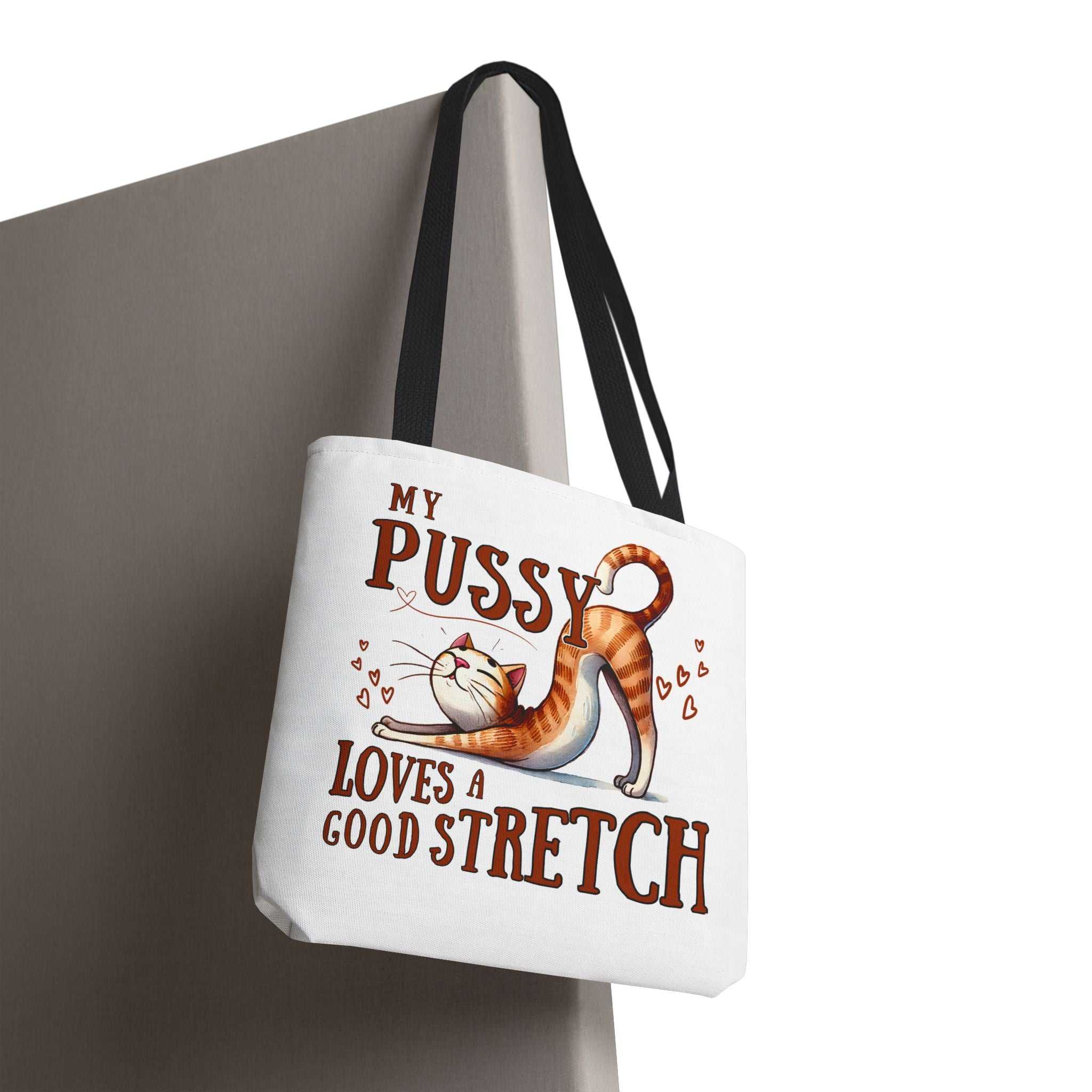 Fun stretching cat tote bag with cheeky design and colorful handles for casual use