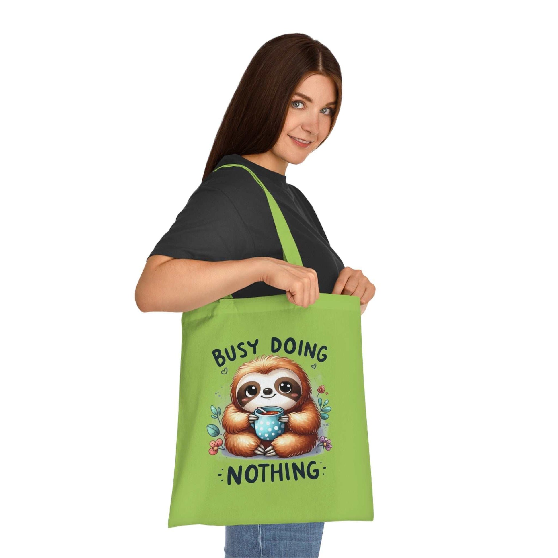 Cute sloth tote bag in vibrant colors with 100% cotton fabric, ideal for carrying essentials.