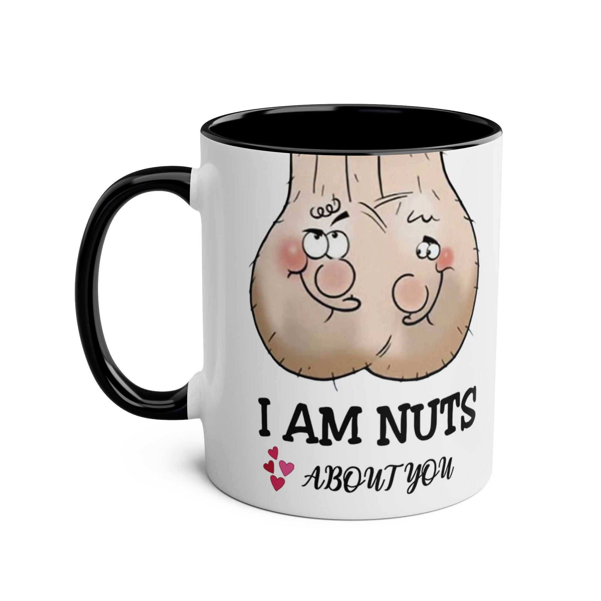 Ceramic mug with "I Am Nuts About You" design, featuring cartoon nuts, black rim, and handle.