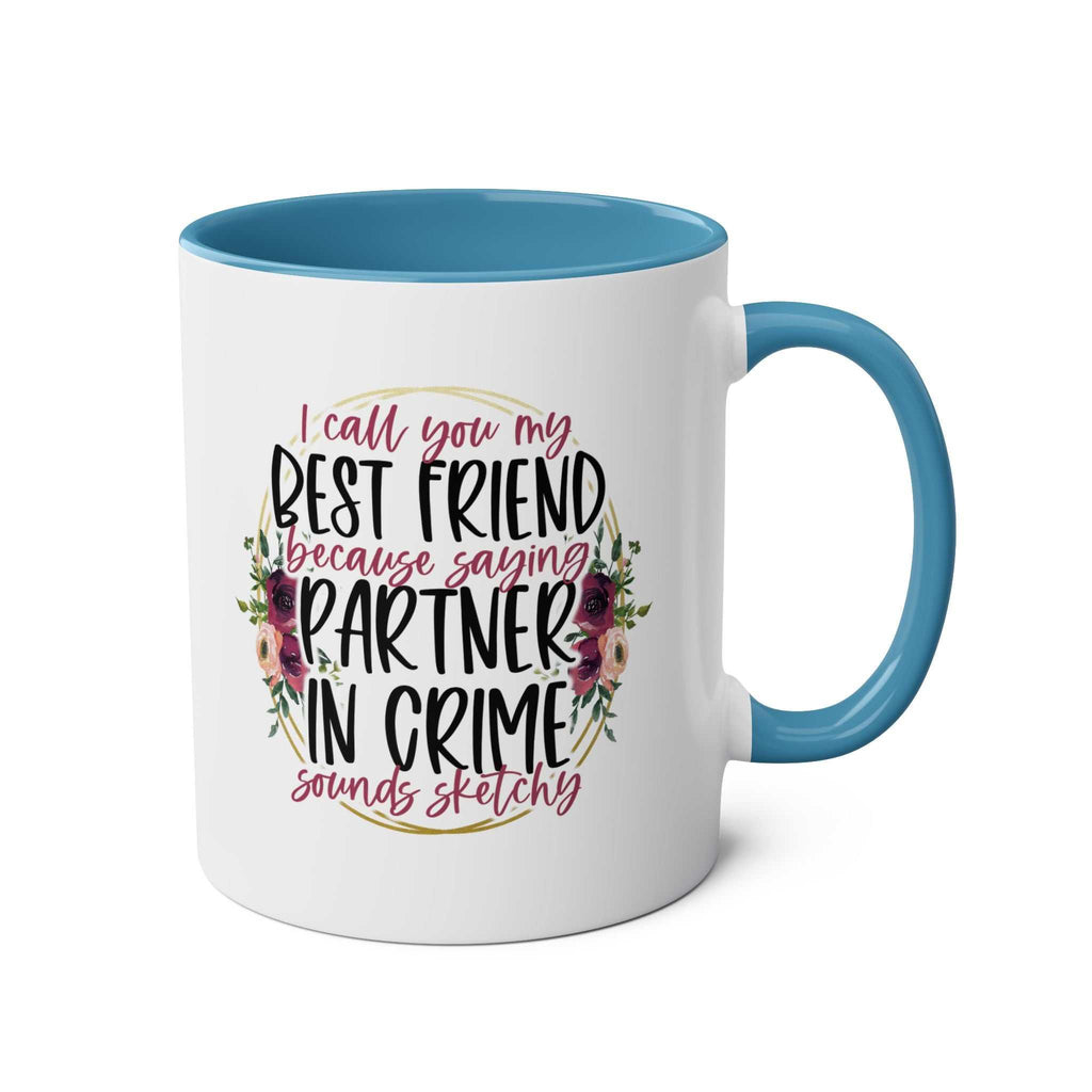 Ceramic mug with "Partner in Crime" message, floral design, and blue interior.