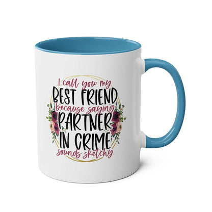 Ceramic mug with "Partner in Crime" message, floral design, and blue interior.