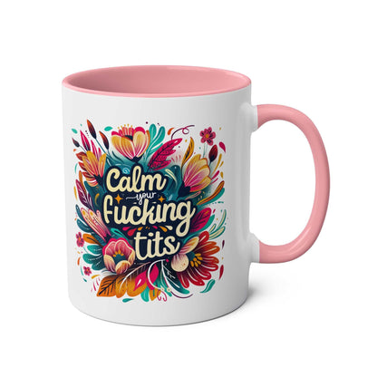 Colorful "Calm Your Tits" coffee mug with floral design, pink handle, and glossy finish.