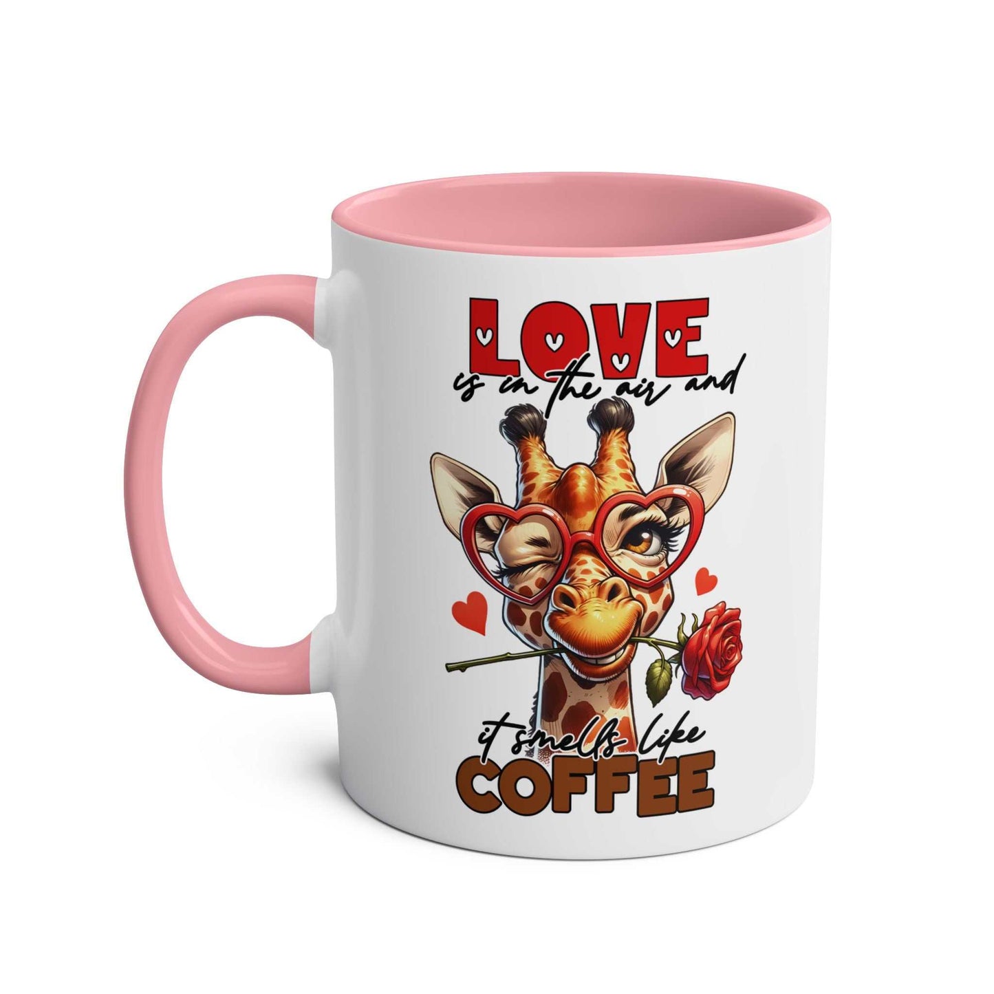 Playful giraffe design on a ceramic coffee mug with pink handle and text "Love is in the air and it smells like coffee."