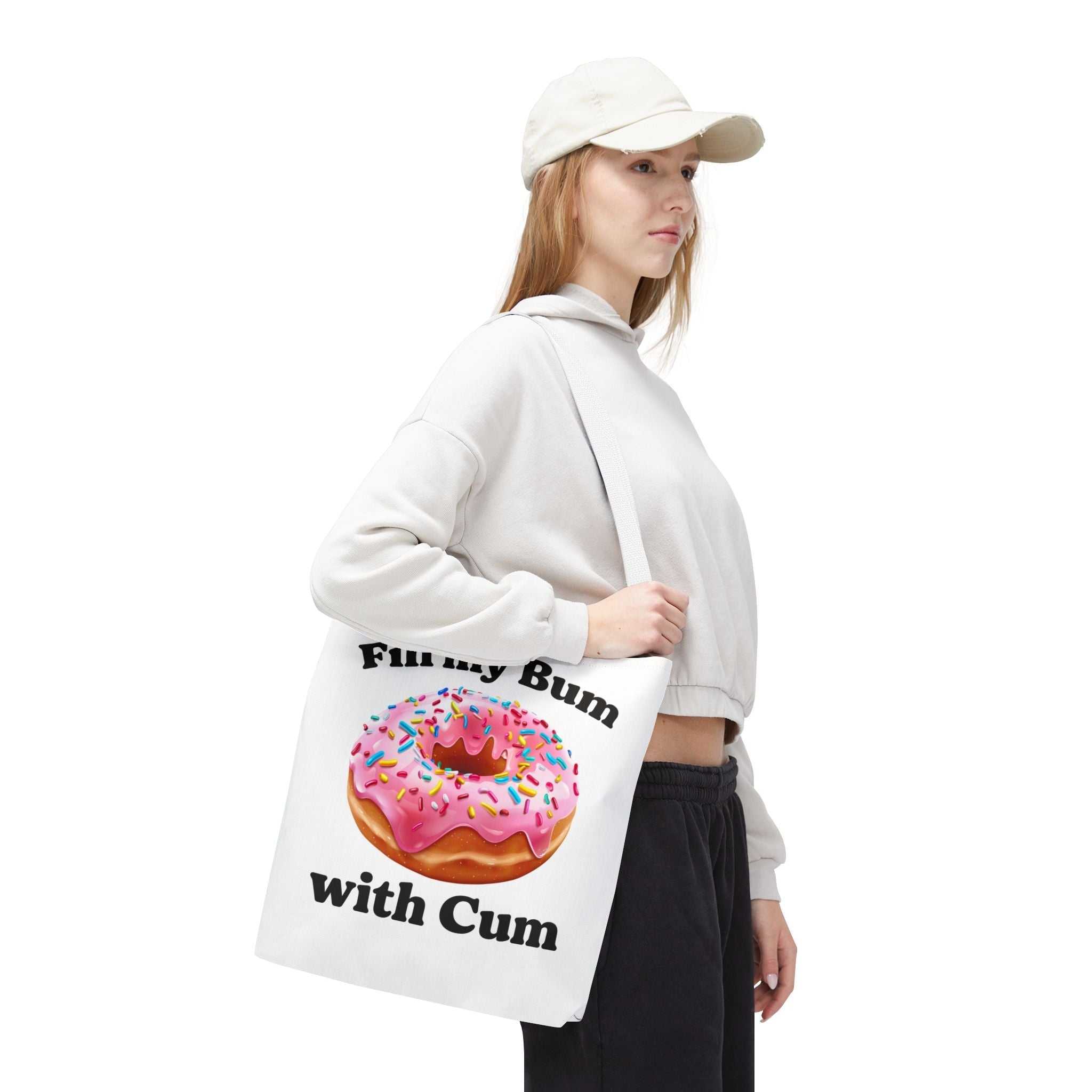 Provocative donut tote bag with cheeky design, durable spun polyester, multiple sizes and handle colors for fun everyday use