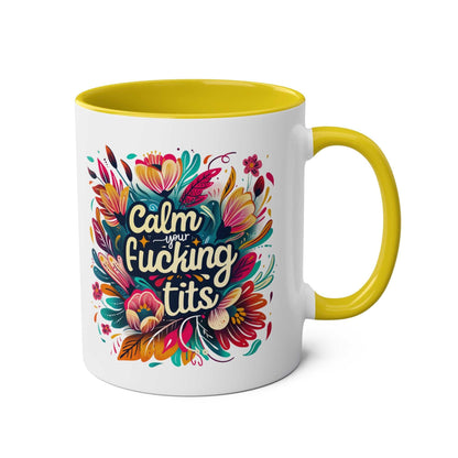 Colorful "Calm Your Tits" coffee mug with vibrant floral design, yellow handle, and interior.