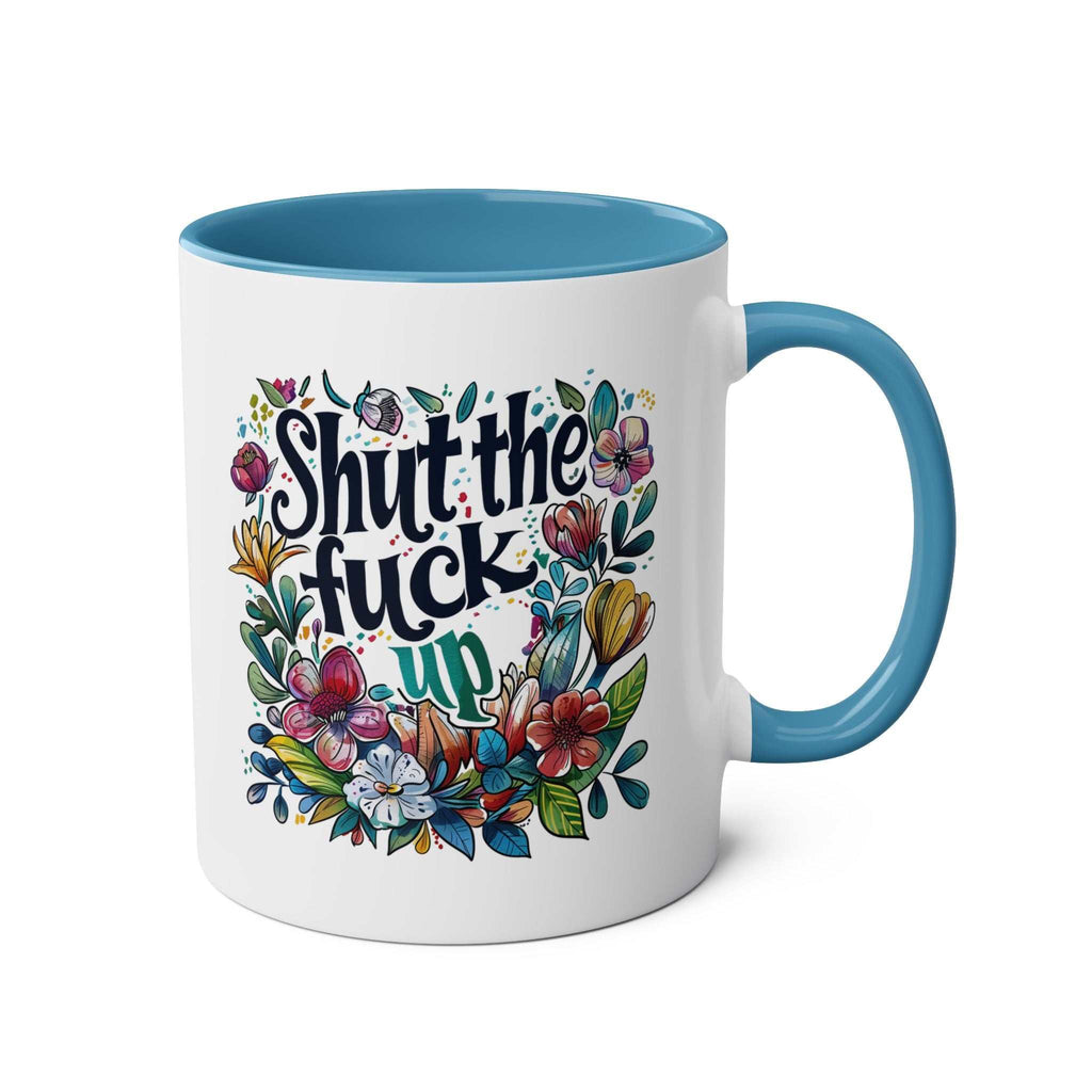 Shut The Fuck Up coffee mug with floral design, blue handle, and interior.