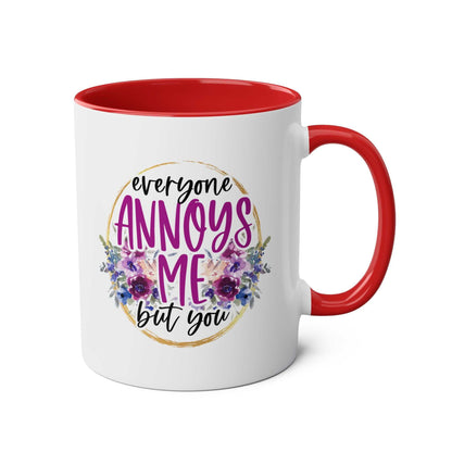 Everyone Annoys Me But You coffee mug with floral design and red interior.
