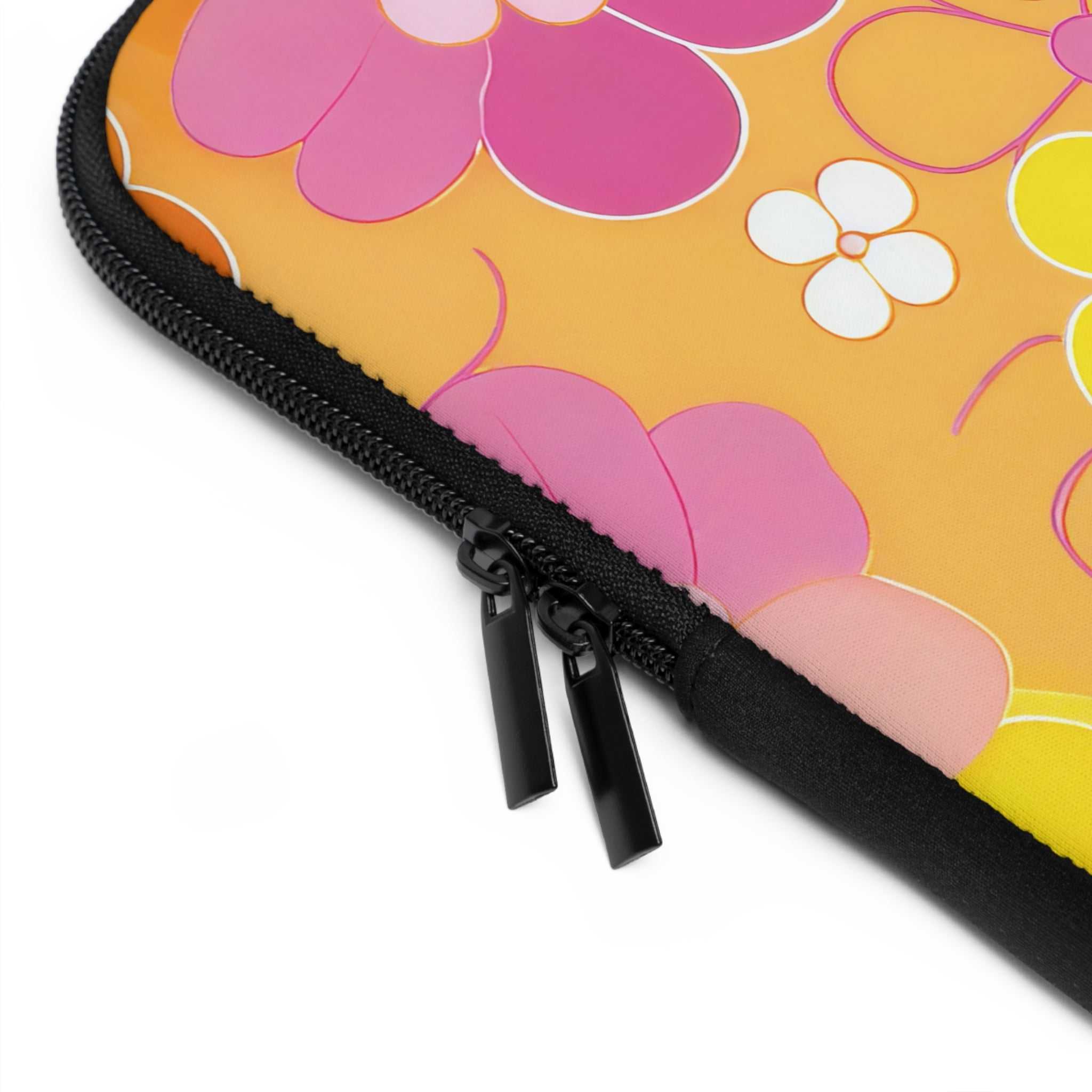 Close-up of retro floral laptop sleeve zipper on vibrant orange neoprene case with pink and white flowers