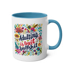 Colorful "Adulting Is Bullshit" coffee mug with floral design, cheeky humor, 11oz ceramic, microwave and dishwasher safe.