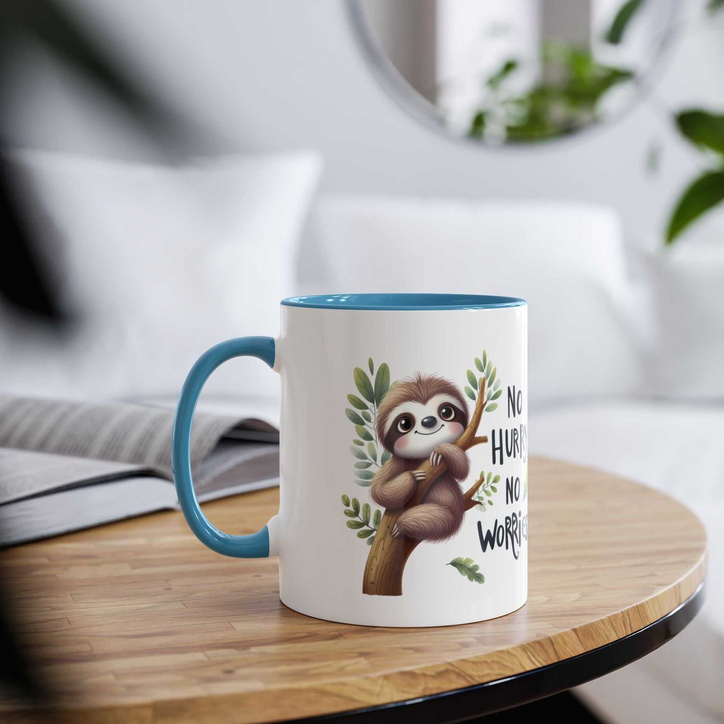 Cute sloth coffee mug with blue interior on a wooden table.