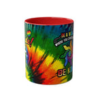 LGBTQ+ Pride mug with vibrant rainbow design on glossy ceramic, featuring positive message and multiple colors.