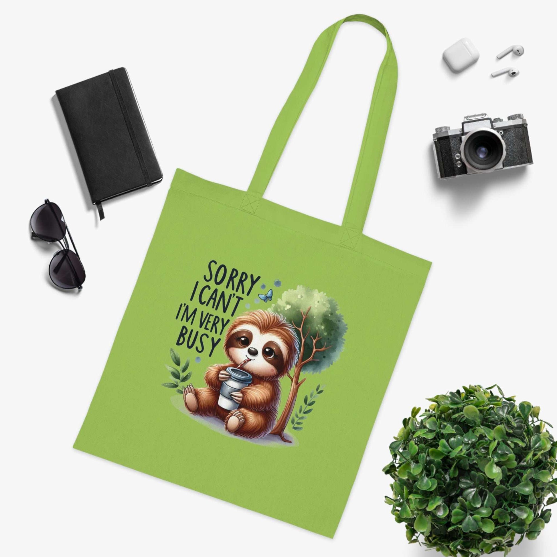 Cute sloth tote bag in vibrant green for essentials, made of durable 100% cotton with whimsical design, perfect for sloth lovers.