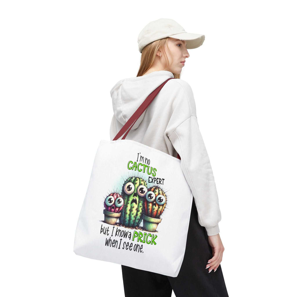 Fun cactus tote bag with cheeky printed design and colorful handles, available in three sizes and made from durable spun polyester.