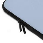 Close-up of misty blue neoprene laptop sleeve with black dual zipper and soft foam lining for protection