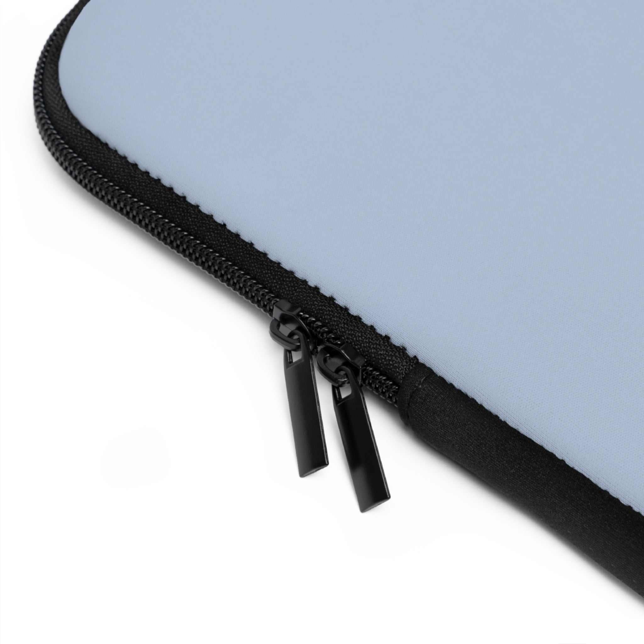 Close-up of misty blue neoprene laptop sleeve with black dual zipper and soft foam lining for protection