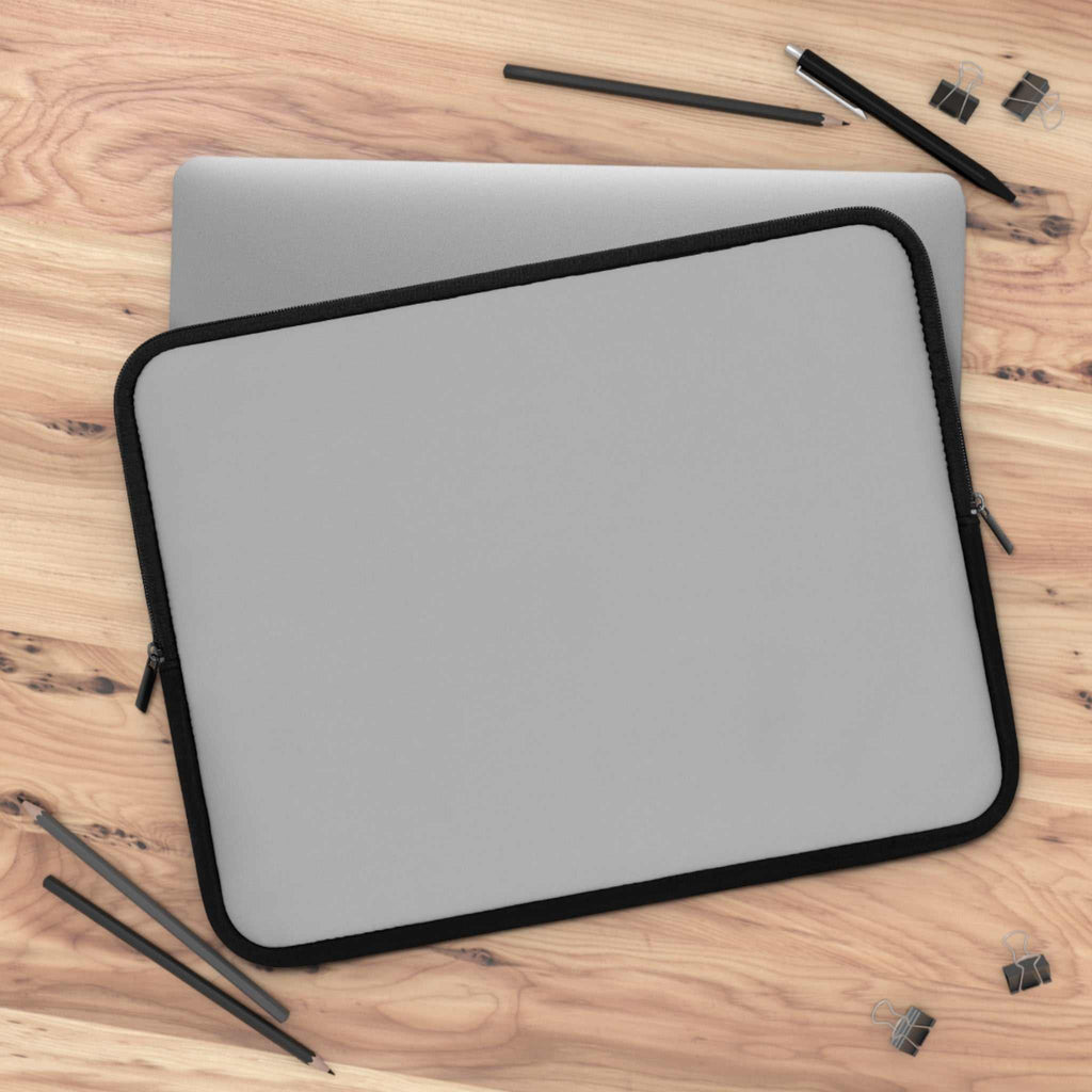 Silver laptop sleeve with black trim, durable neoprene, soft foam lining, dual zipper, lightweight and waterproof protection for laptops